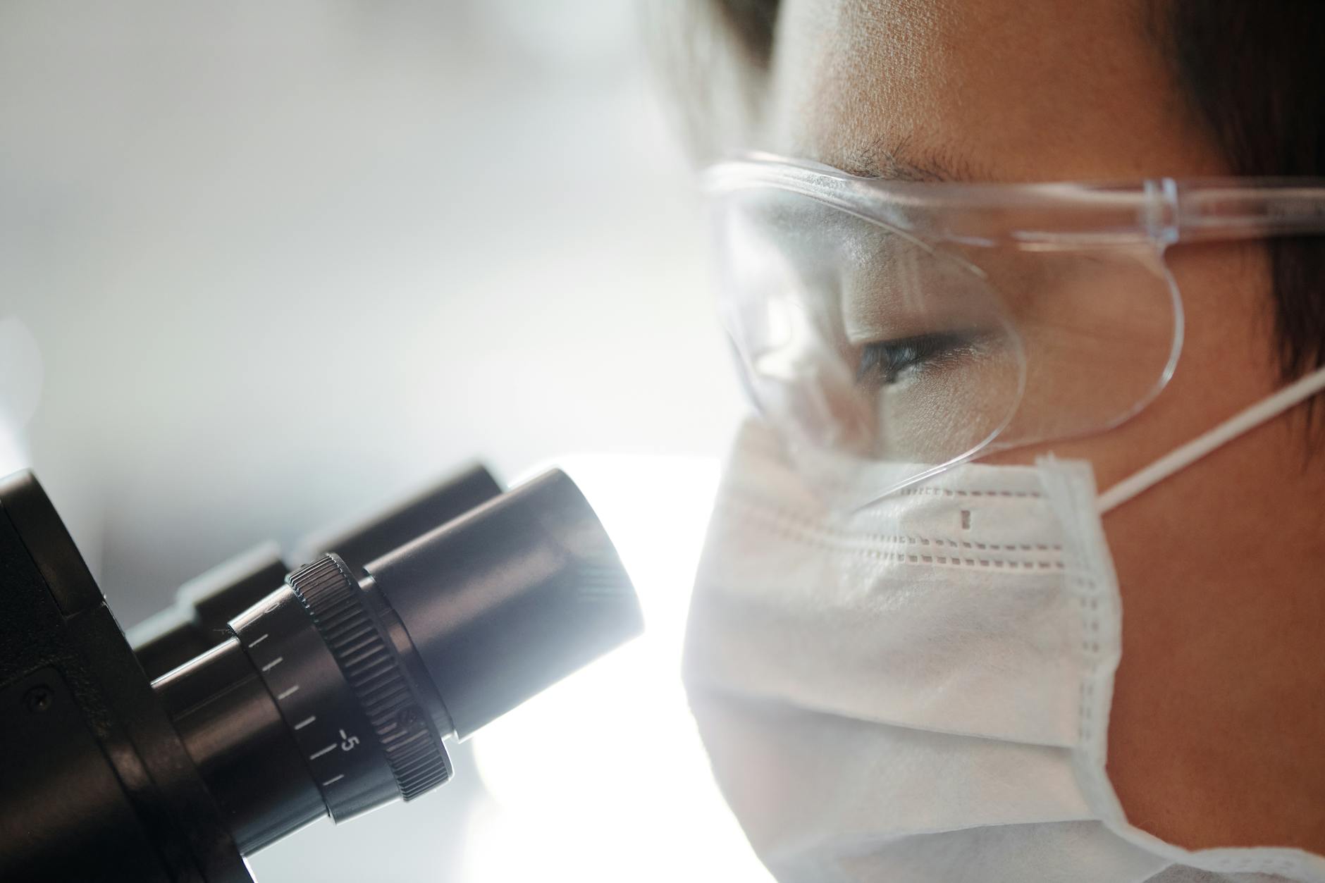 man looking through a microscope